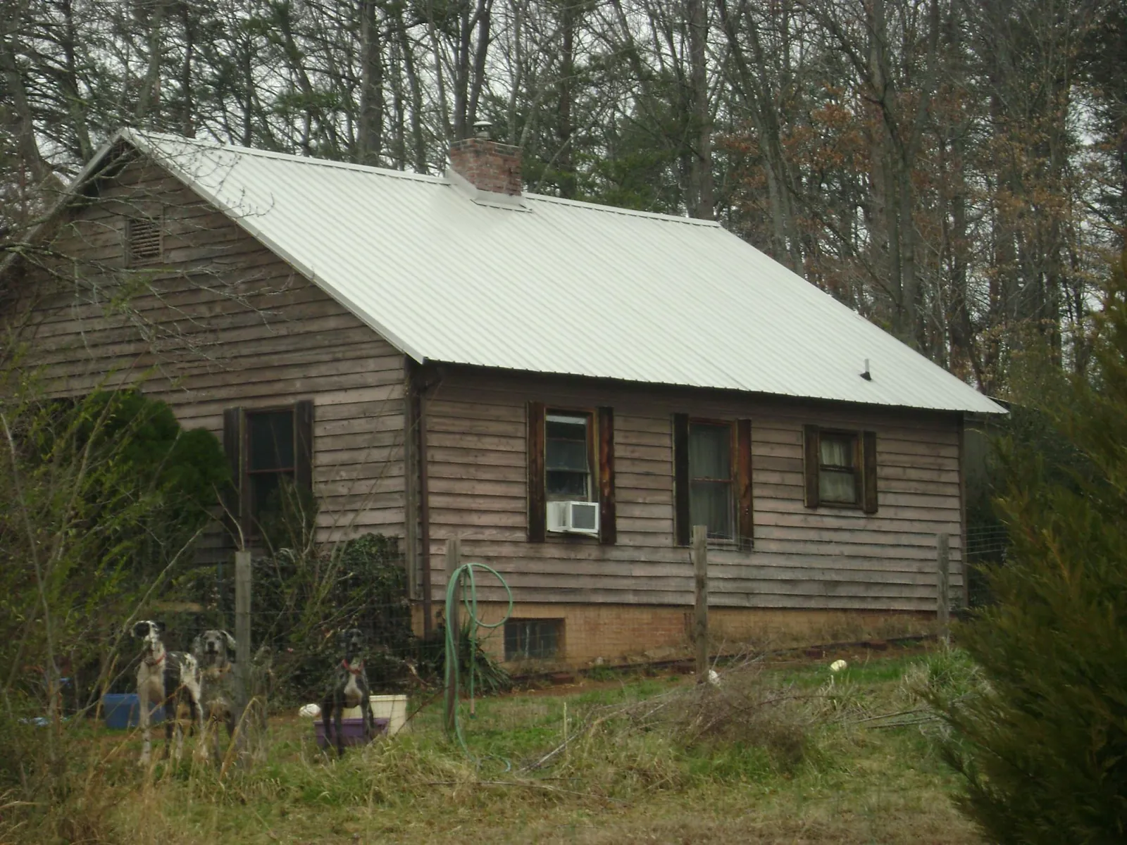 White metal roof on an old wood sided farmhouse, from a Asphalt Shingle Roof Repair job in Glassport